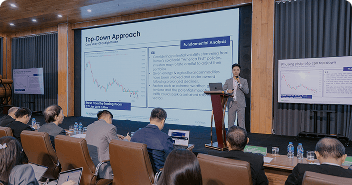 Speaker presenting market analysis